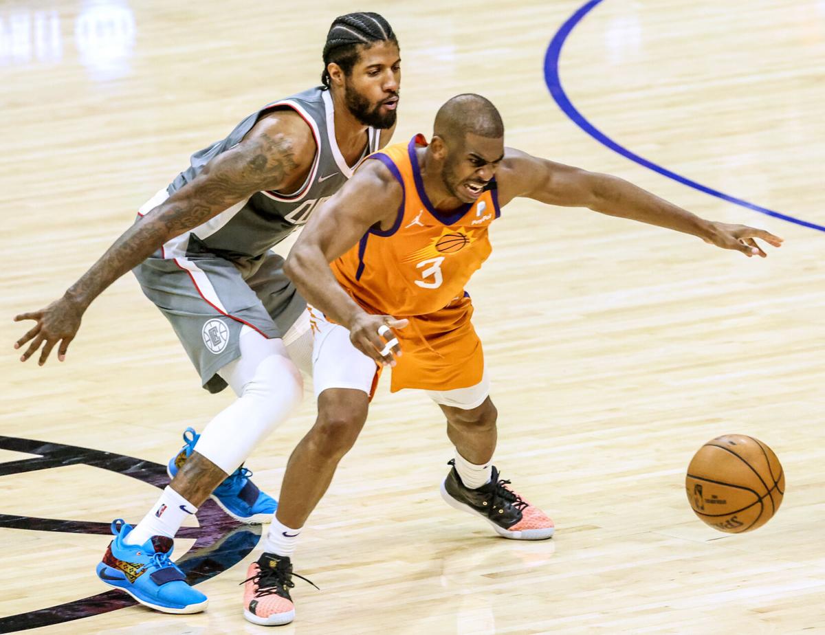 The Los Angeles Clippers' Paul George closely guards the Phoenix Suns' Chris Paul late in Game 4 of the NBA Western Conference Finals at Staples Center in Los Angeles on Saturday, June 26, 2021. The Suns won, 84-80, for a 3-1 series lead, which they went on to win. Now the question is, will Paul re-up with Suns or sign somewhere else.
