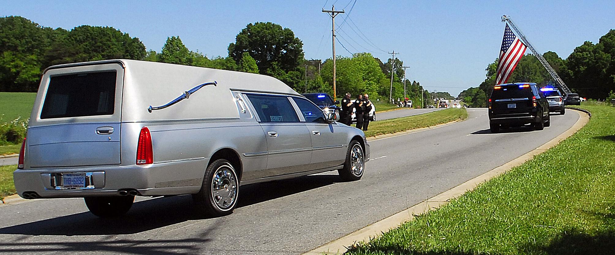 Procession escorts slain officer to Newton funeral home