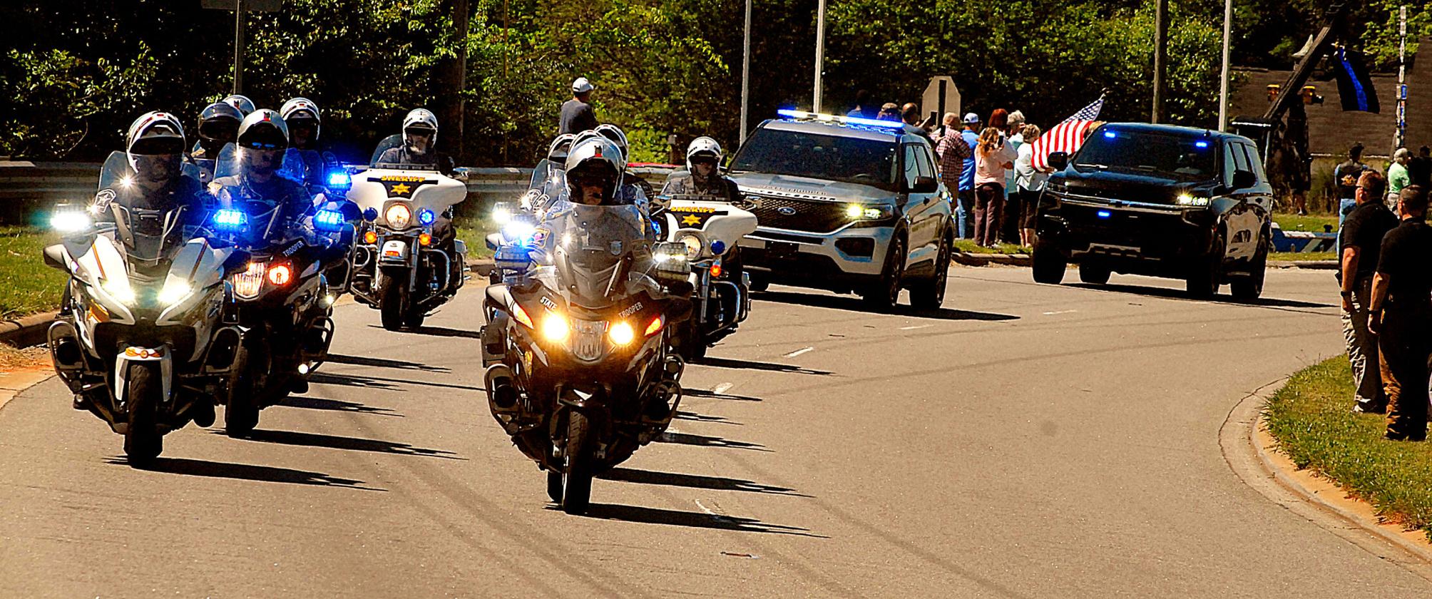 Procession escorts slain officer to Newton funeral home