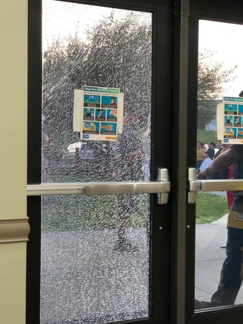 A door to the Career Academy & Technical School where Iredell-Statesville Schools held Monday's meeting was broken by protesters outside in Troutman on Monday.