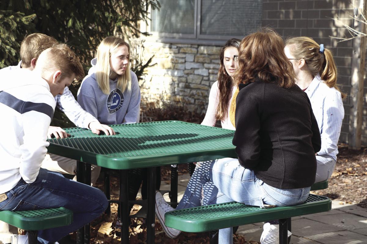 Students sit at table