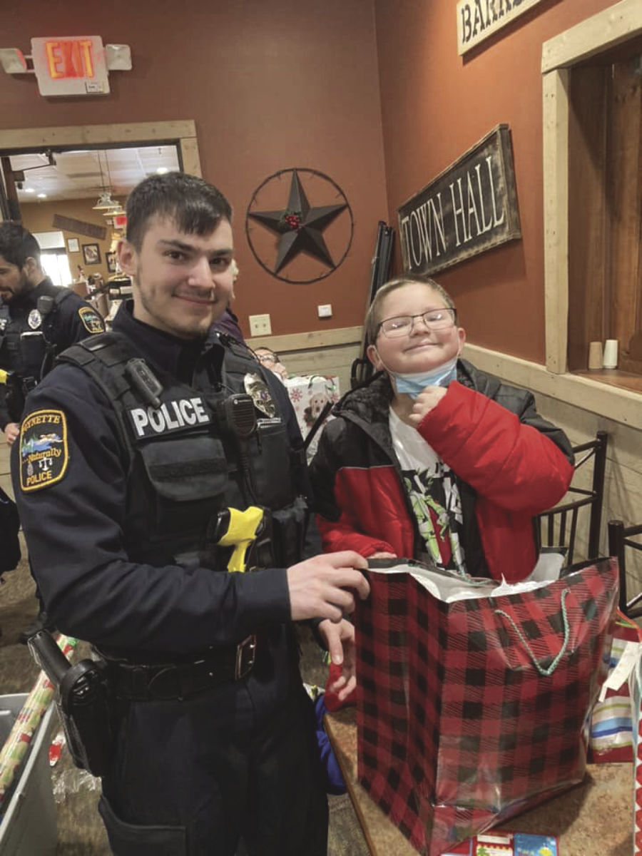 Officer Reinhardt helps wrap