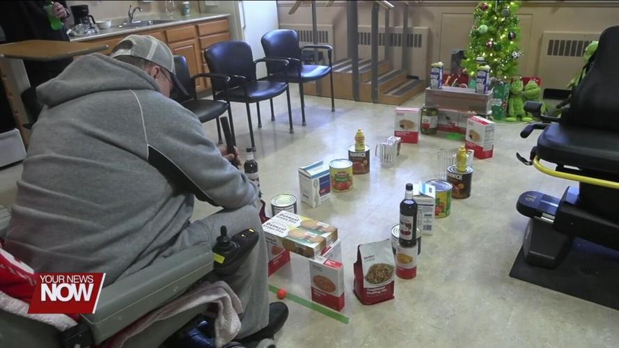 Lima Convalescent Home residents show off their putt-putt golf skills