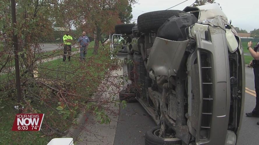 Lima Police investigating crash involving a minivan hitting a tree and coming to rest on its side