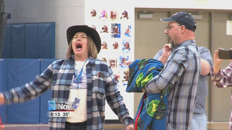 Principal at Allen East kisses a pig for the kids