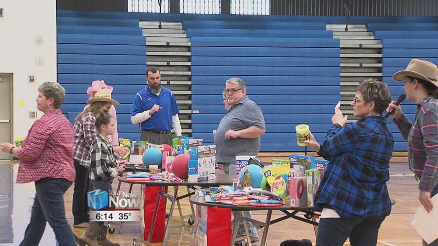 Principal at Allen East kisses a pig for the kids