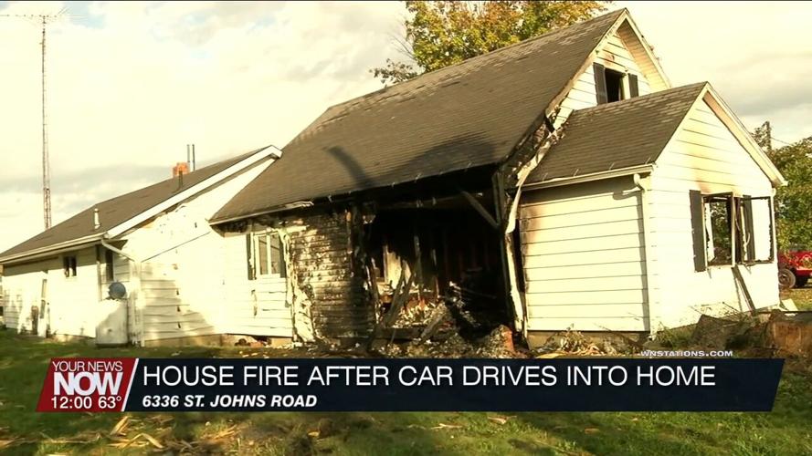 Multiple fire crews assist with fire after a vehicle crashes into a Perry Township home
