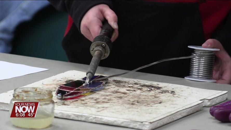Students at Liberty Arts Magnet get a demonstration of how to create stained glass