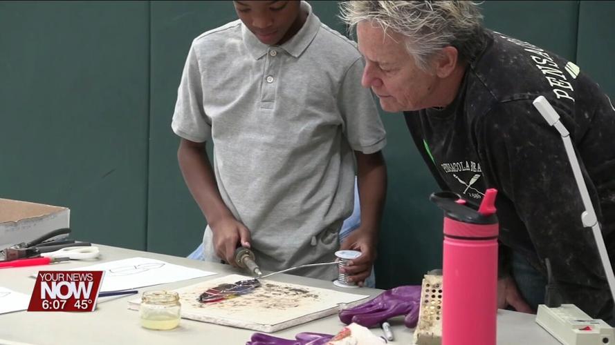 Students at Liberty Arts Magnet get a demonstration of how to create stained glass