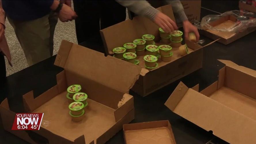 Lima Rotary and Bath Interact Club help pack boxes for the West Ohio Food Bank