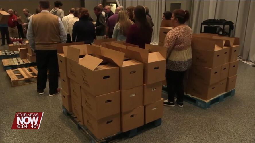Lima Rotary and Bath Interact Club help pack boxes for the West Ohio Food Bank