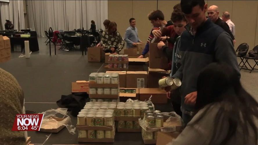 Lima Rotary and Bath Interact Club help pack boxes for the West Ohio Food Bank