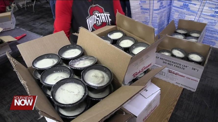 Volunteers and West Ohio Food Bank staff prepare Christmas Eve ham dinners