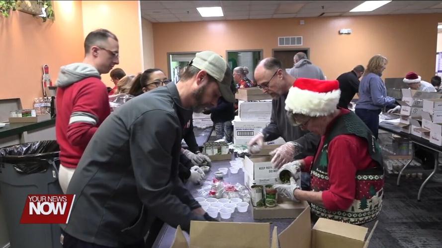 Volunteers and West Ohio Food Bank staff prepare Christmas Eve ham dinners