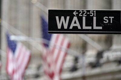 Wall Street sign with flags in the background