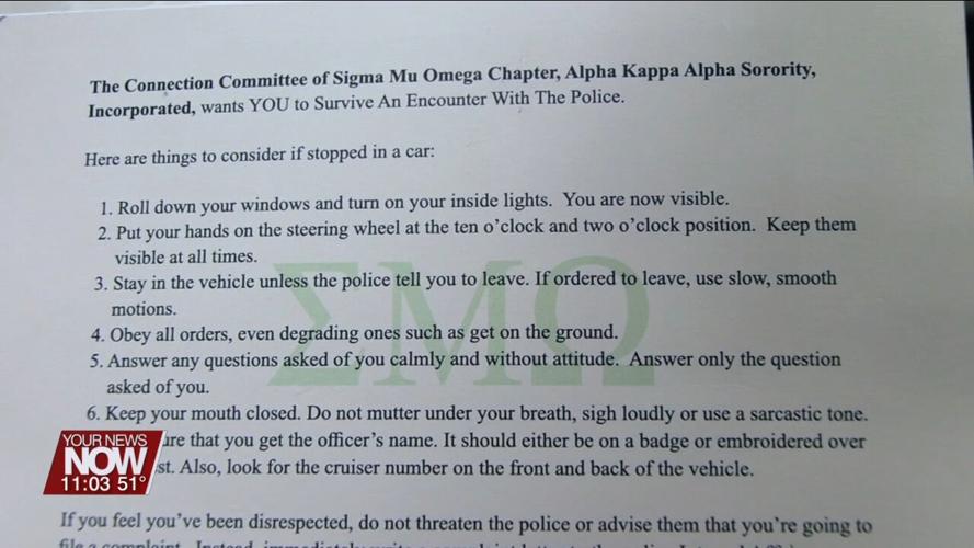 Lima city councilman Derry Glenn distributing cards about how to act when pulled over by police