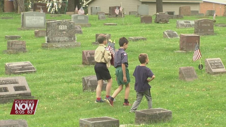 Scouts place flags on Shawnee Cemetery graves ahead of Memorial Day