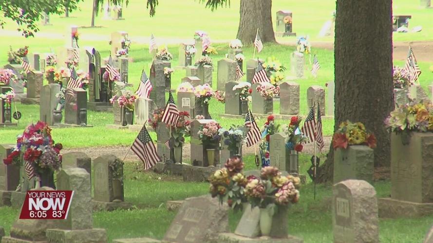 Scouts place flags on Shawnee Cemetery graves ahead of Memorial Day