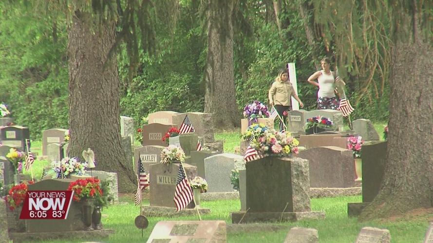 Scouts place flags on Shawnee Cemetery graves ahead of Memorial Day