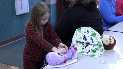 Students tuck in their stuffed animals for a sleepover at Unity Elementary