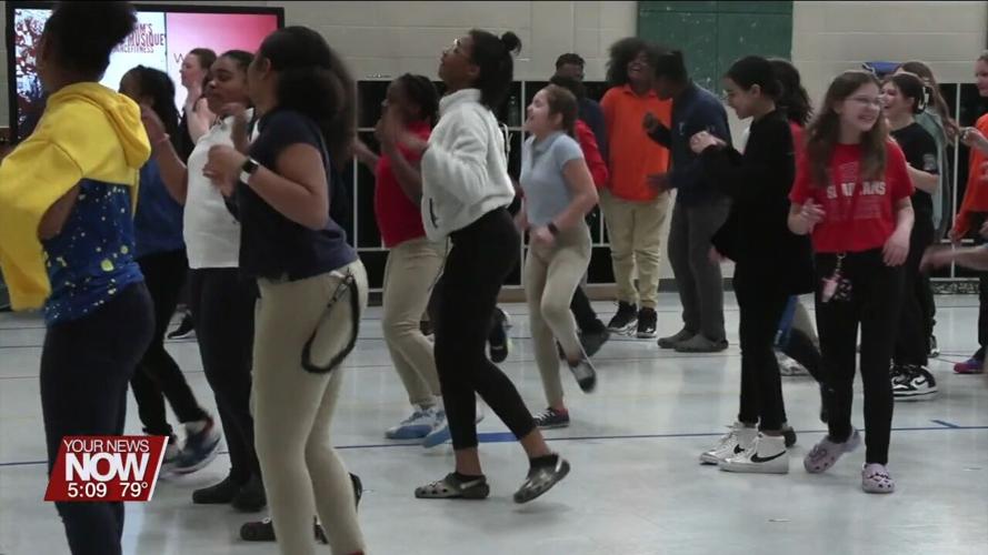 Instructor from Rhythm Musique shows some dance moves to Liberty Arts Magnet School students