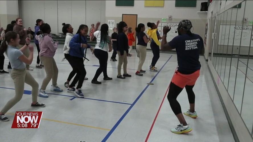 Instructor from Rhythm Musique shows some dance moves to Liberty Arts Magnet School students