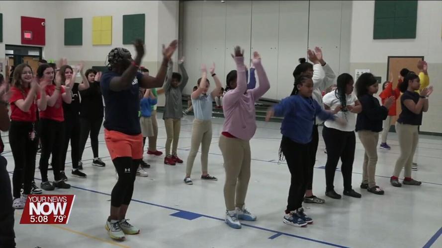 Instructor from Rhythm Musique shows some dance moves to Liberty Arts Magnet School students