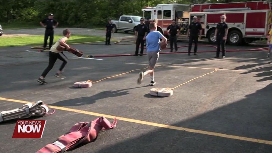Bath Elementary 5th graders celebrate the completion of their D.A.R.E. program with Bath Township firefighters