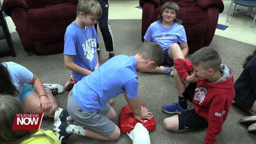 Bath Elementary 5th graders celebrate the completion of their D.A.R.E. program with Bath Township firefighters