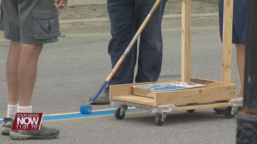Wapakoneta Breakfast Optimist Club paints blue line to honor law enforcement