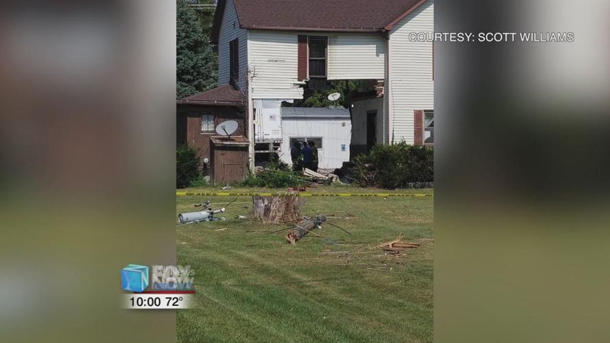 Semi truck drives through a house and crashes into gas station
