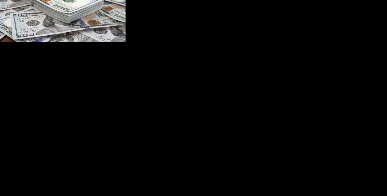 Stack of one hundred dollars notes on dollars background