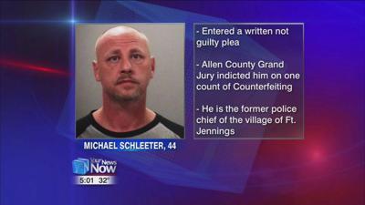 Former police chief pleads not guilty to counterfeiting charge