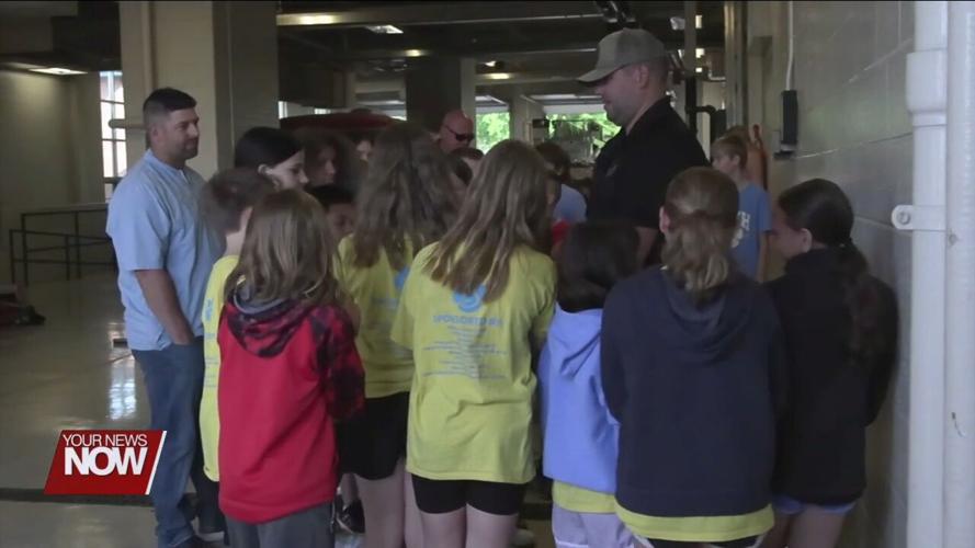 Bath Elementary 5th graders celebrate the completion of their D.A.R.E. program with Bath Township firefighters