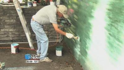Artist working on new mural in Pandora