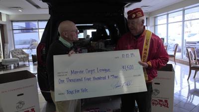 Tom Ahl Dealerships donate toys and $1,500 to Toys for Tots
