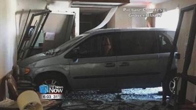 A man drives his minivan into a building
