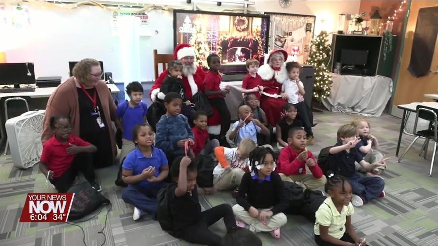 Santa and Mrs. Claus make a stop at Unity Elementary to pass out gifts to excited students