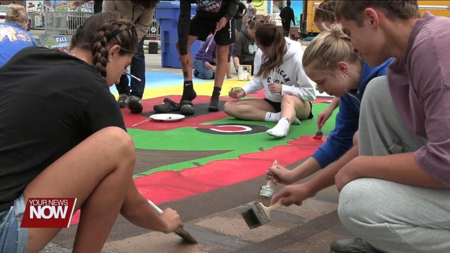 High School Art Club students paint mural on Main Street for annual Continental Fall Festival
