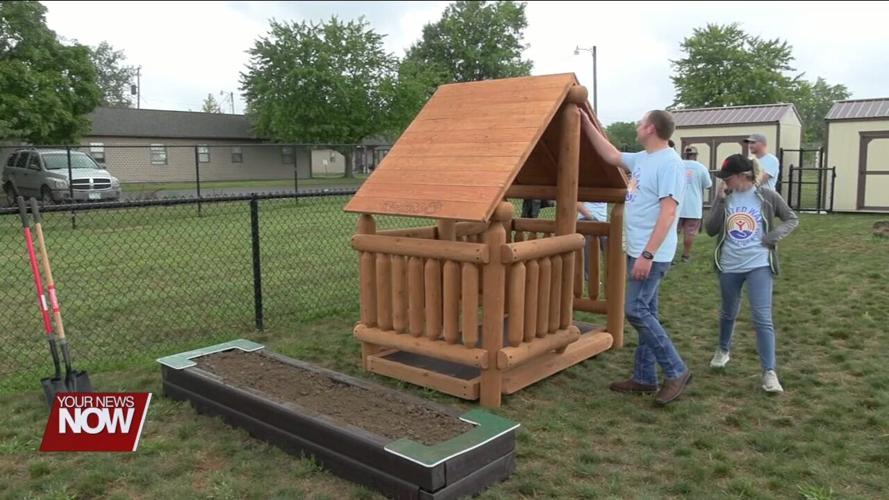 Local volunteers construct new playhouse for Head Start children