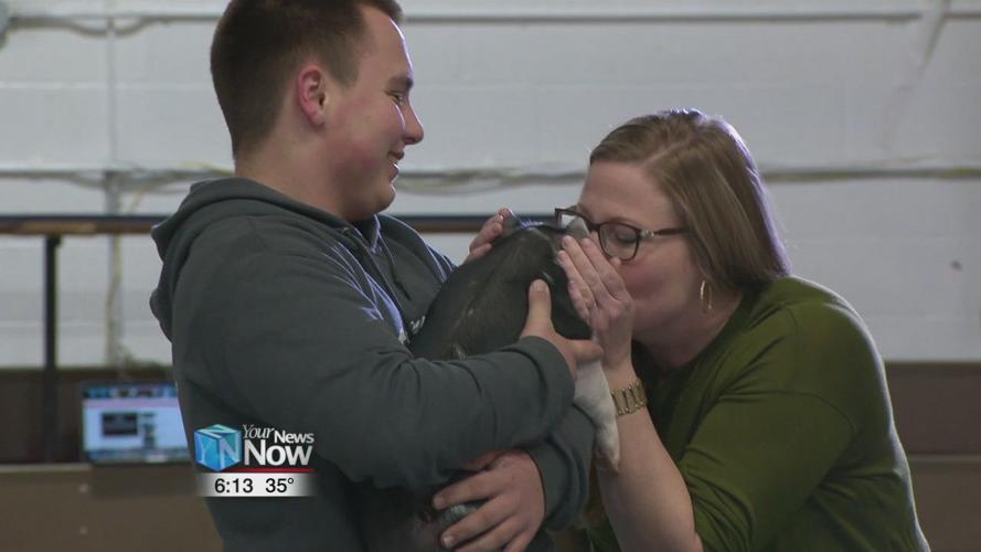 Teachers at Temple Christian Schools kiss a pig for a cause