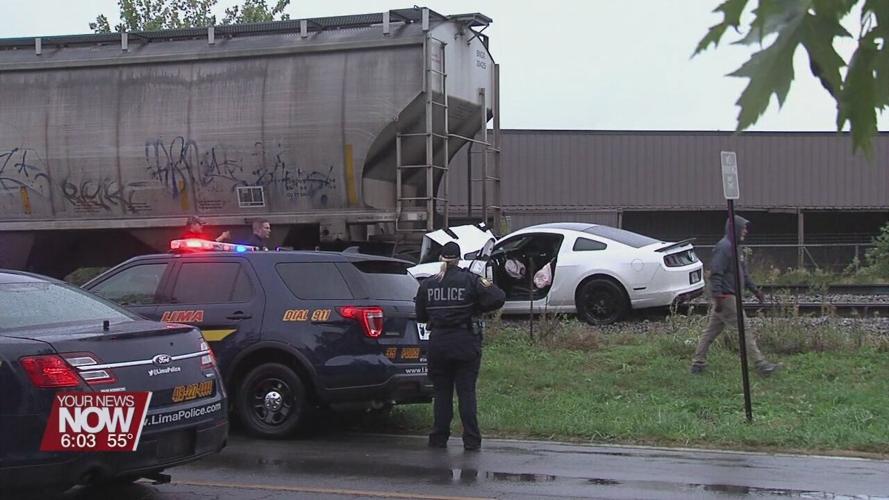 Man hospitalized after crashing car into train car