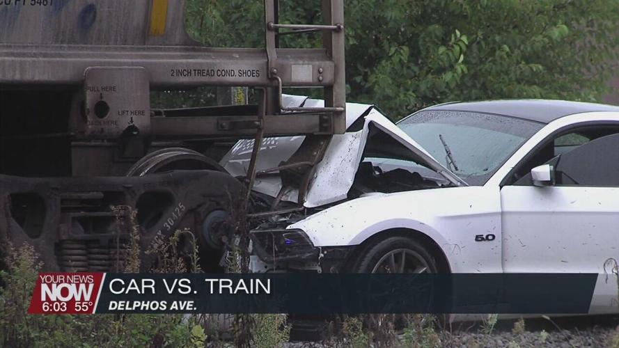 Man hospitalized after crashing car into train car