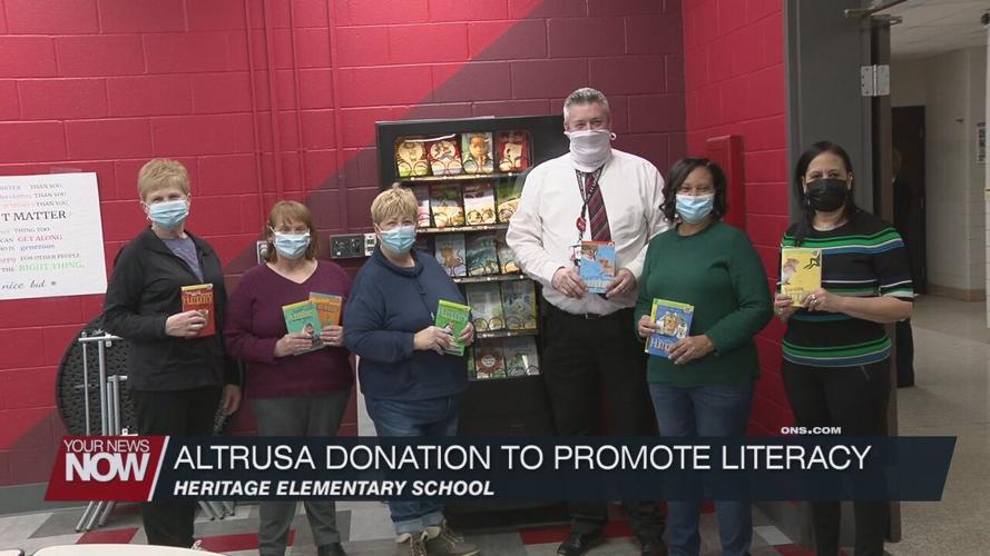 Altrusa of Lima donates books and a check to support literacy at Heritage Elementary