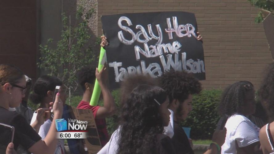 Protesters chant "NO JUSTICE, NO PEACE" as they march through downtown Lima