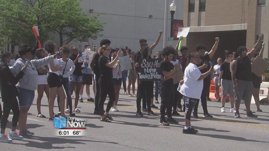 Protesters chant "NO JUSTICE, NO PEACE" as they march through downtown Lima