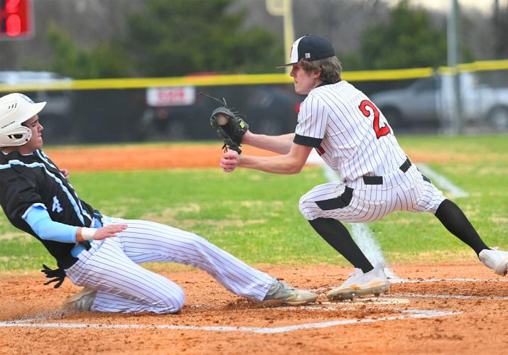Trinity’s Camden Nelson slides to home plate
