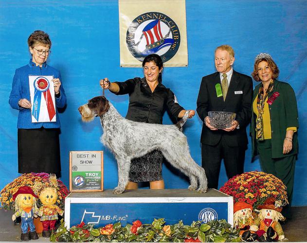 Roz Kramer (far left), of High Point, poses with the "Best In Show"