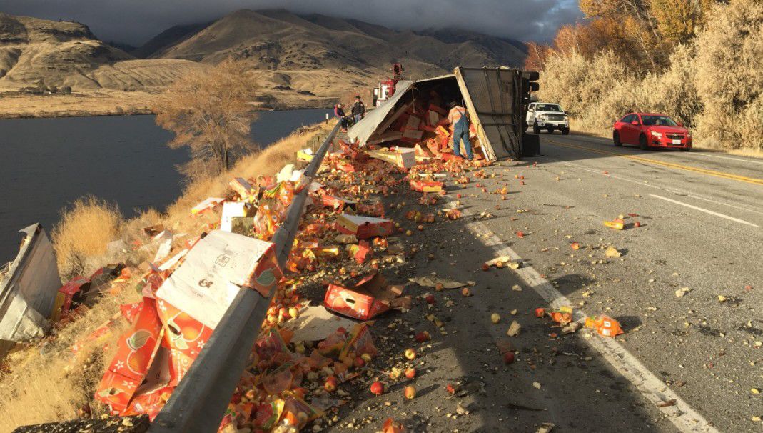 Semitruck hauling boxed apples rolls on Highway 2 near Wenatchee