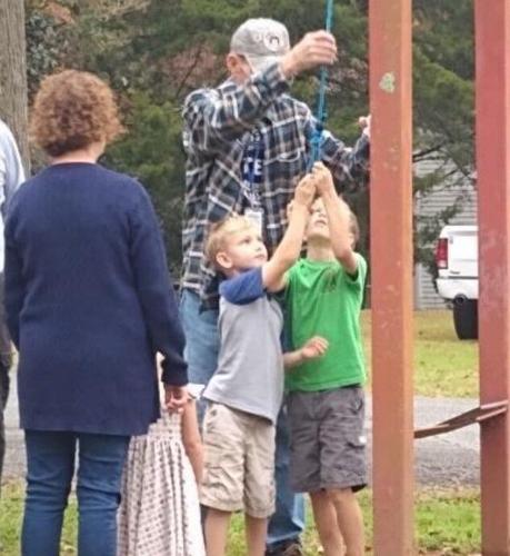 Ringing the bell to honor a veteran